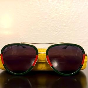 Gucci sunglasses with gold trim.